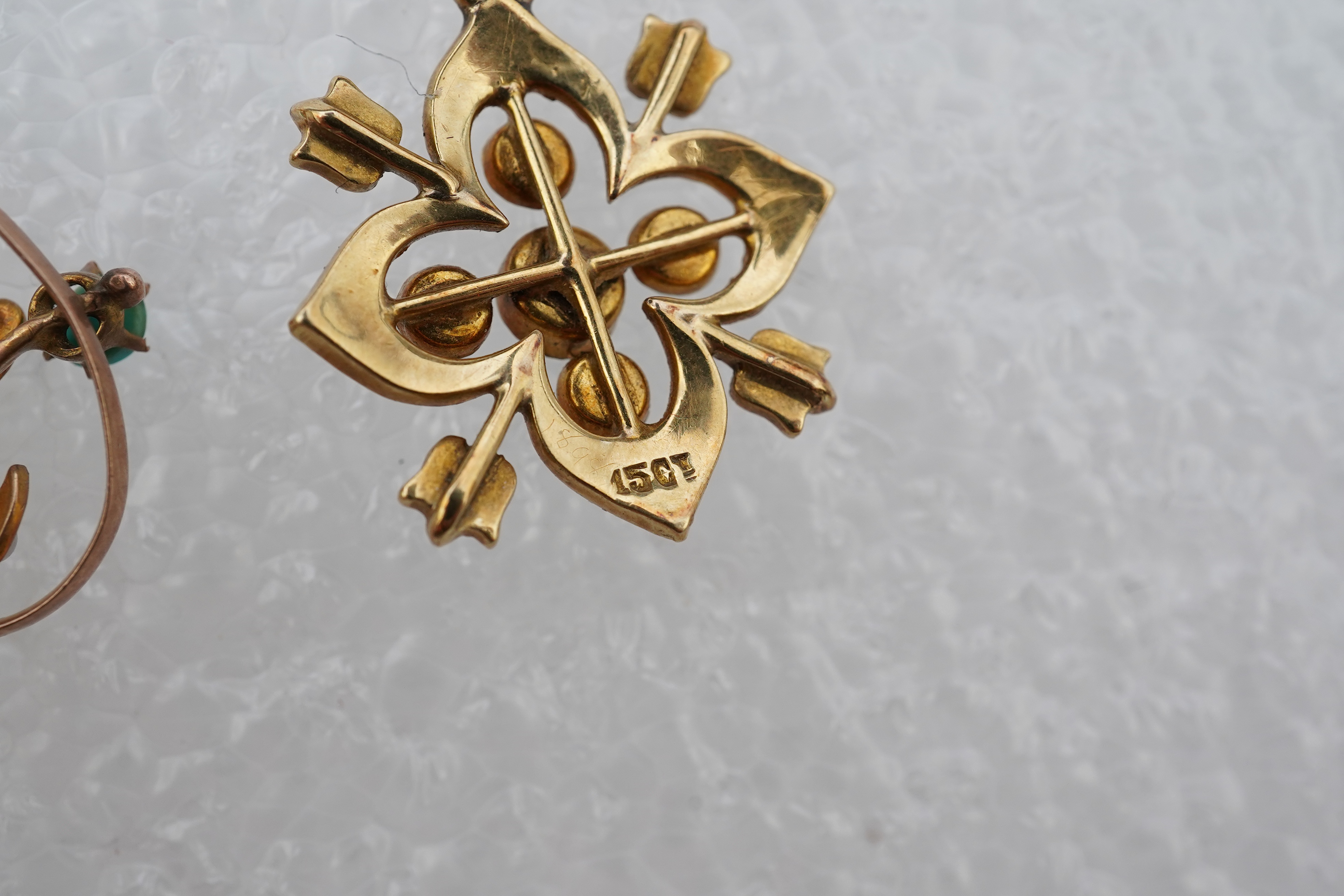 Two Edwardian turquoise and seed pearl pendants, each of foliate design, set with turquoise cabochons and seed pearls, mounted in gold, longest 3.7cm, smaller stamped 15CT, combined gross weight approximately 4 grams